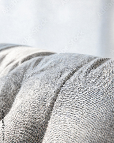 Macro close-up of gray linen sofa fabric texture with soft folds