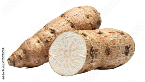 Whole and sliced raw cassava root with brown textured skin and white starchy interior flesh isolated on a transparent background