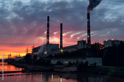 Konstfotografi Power plant smokestacks emitting dark smoke at sunset reflecting industrial poll