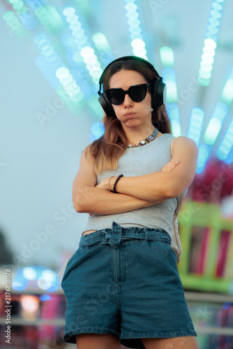Canvas Print Sulking Stressed Woman With Crossed Arms Wearing Sunglasses in Amusement Park