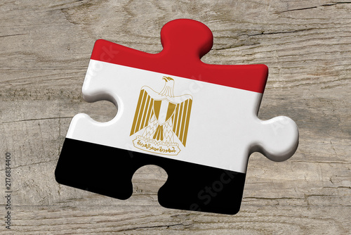 3D illustration. Flag of Egypt on a jigsaw puzzle pieces on a wood background.