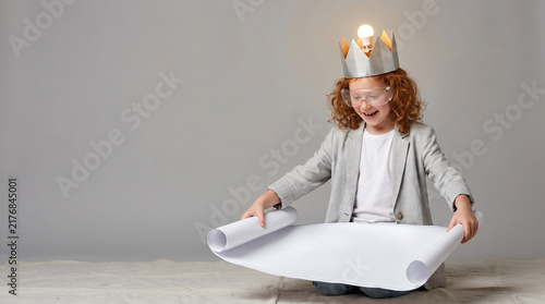 Child Scientist Working With Blueprint