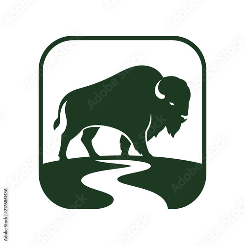 Obraz na plátne Green bison silhouette logo icon standing on a landscape hill inside a rounded s