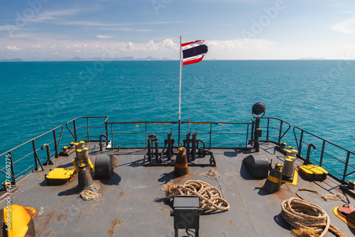 Obraz na płótnie Ferry Bow Deck with Thai Flag Facing Turquoise Sea