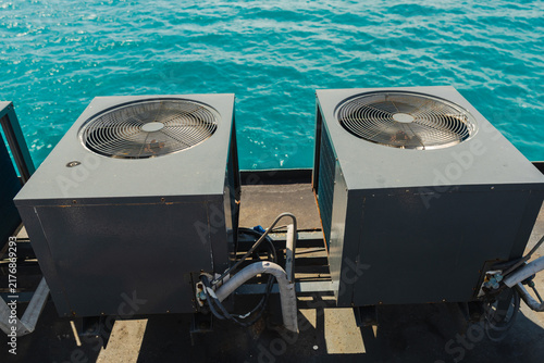Фотография Twin Air-Conditioning Units on Ferry Deck Above Turquoise Sea