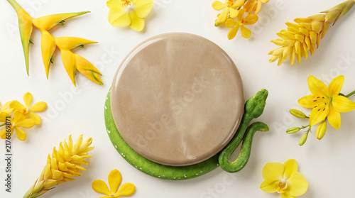 Beautiful top-down flat lay perspective photography of a Warm Beige polished concrete floating pedestal podium surrounded by a green tree python and bright yellow tropical flowers. 