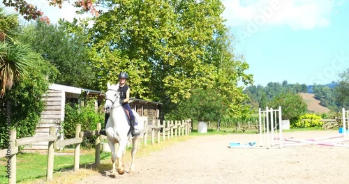 Beautiful young female rider tgalopping on her horse in slow motion