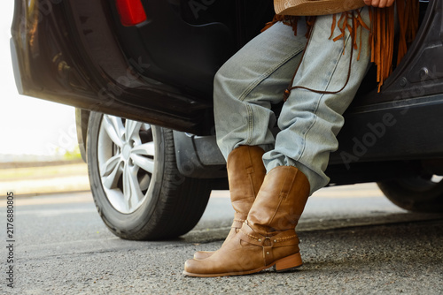 Fotografie Road trip adventure and travel freedom, woman wearing cowboy boots and fringe ja