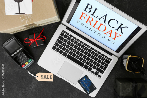 Laptop with text BLACK FRIDAY COUNTDOWN, credit card, presents and payment te...