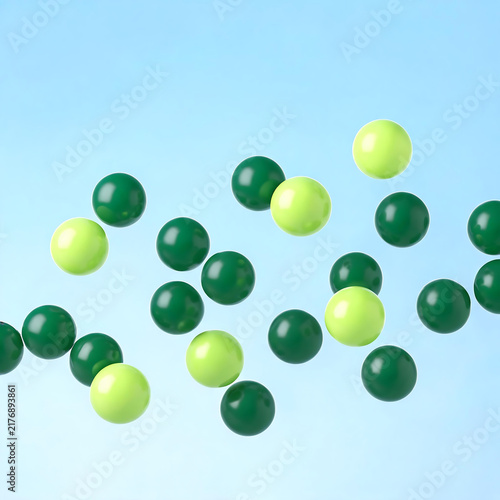 Glossy green and lime spheres floating in air isolated on pastel blue background 3D rendering
