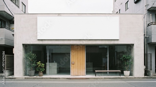 Modern Building Facade with Large Blank Signage and Glass Windows.