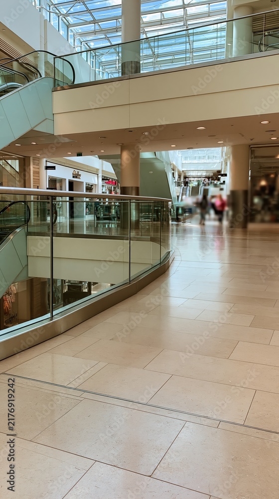 Obraz premium Modern shopping mall interior with glass railings and