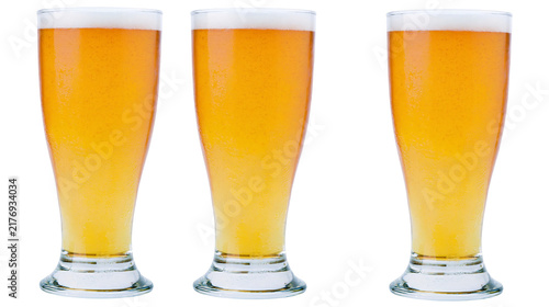 Obraz na plátně Three tall pilsner glasses filled with golden lager beer and thick white foam