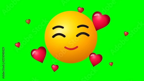 Smiling yellow character face with floating glossy red hearts on green background