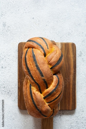  Pumpkin marbled (tiger print) bread with cuttlefish ink, braided on a light background. Useful home baking. Texture laid out from slices of bread.