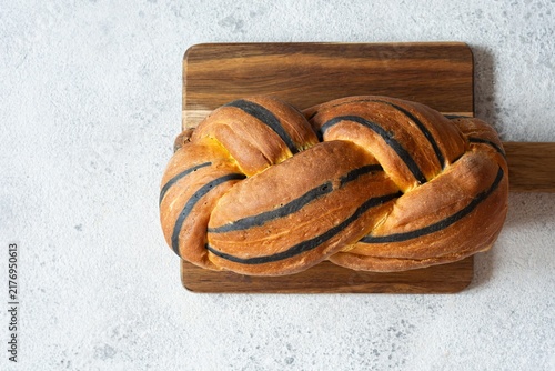 Pumpkin marbled (tiger print) bread with cuttlefish ink, braided on a light background. Useful home baking. Texture laid out from slices of bread.