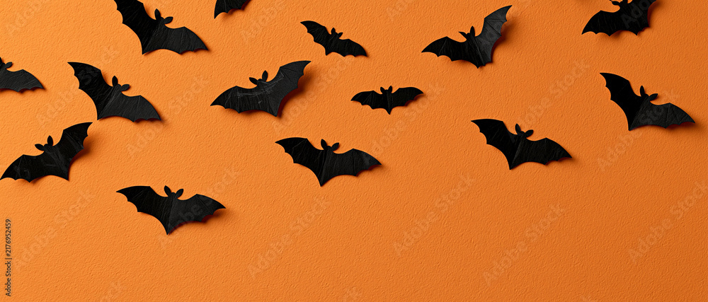 Fototapeta premium Paper Bats Flying on Orange Background Halloween Banner