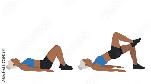 Older woman performing single leg glute bridge on floor in workout studio showing hip lift, core engagement and lower body strength training