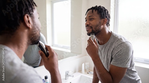 black man beard trimming razor mirror bathroom grooming hygiene wellness captures a focused morning routine for masculine beauty personal care skincare brands and modern lifestyle campaigns