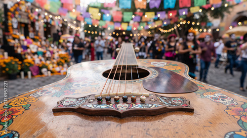 Decorated acoustic guitar with sugar skull paintings on street of Mexican festival. Day of Dead celebration with people crowd, marigold flowers, flags