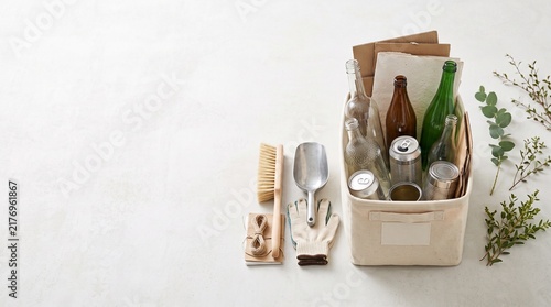 Recyclable household waste in a storage bin with cleaning tools