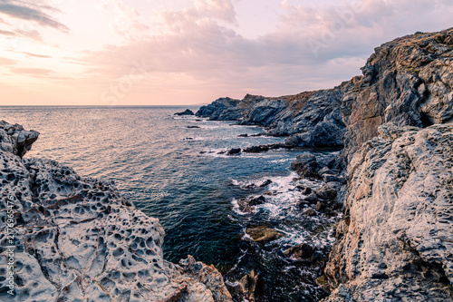 Morning sunrise on the rocky coastline of the sea