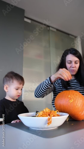 Scooping pumpkin seeds into bowl