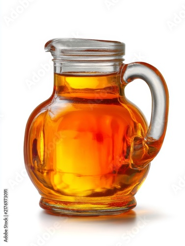 Elegant glass jug filled with golden amber maple syrup. Perfect for breakfast table and culinary use. Enhance pancakes waffles and desserts with rich flavor. Generative AI