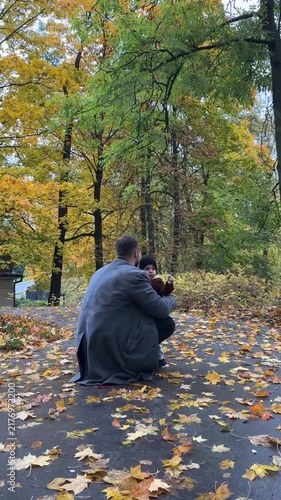 Father playing with child in leaves