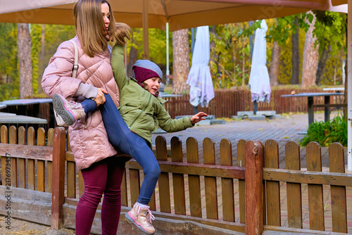 Tired mother is dealing with her naughty mischievous child daughter