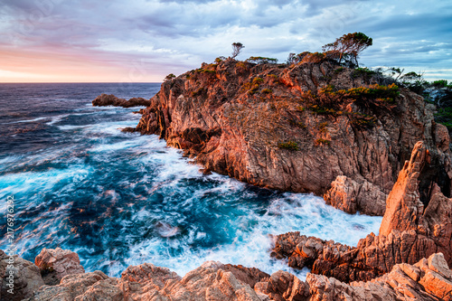 Magic sunrise on the rock coastline with colorful sky (Costa Brava, Tamariu, Spain)