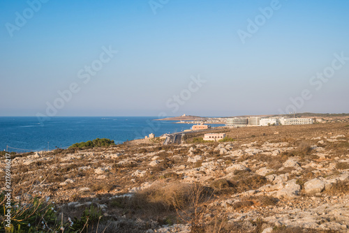 Arid and rocky landscape overlooking the sea, road and Wied Musa Battery, Marfa MALTA