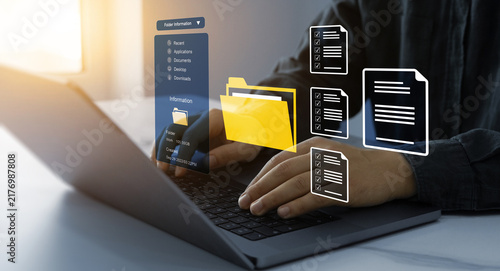 Process automation to efficiently manage files. Businesswoman working on laptop with virtual screen. Online documentation database and document management system concept.	
