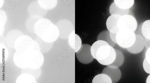 Abstract blurred lights background with white and black bokeh circles