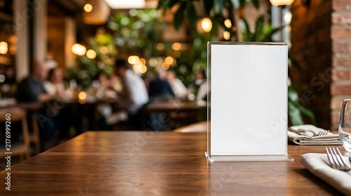 Blank sign stand on restaurant table with blurred customers in background
