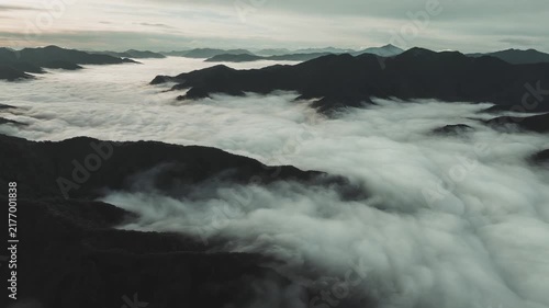 Mystical Sea of Clouds Over Mountain Range at Sunrise or Sunset