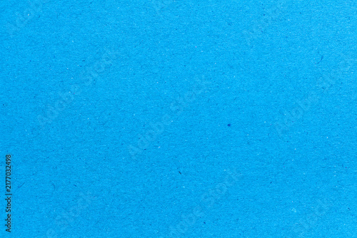 blue paper background texture light rough textured spotted blank copy space background in blue