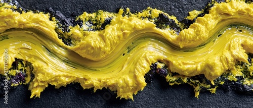 Yellow Paint Texture on Dark Stone Surface