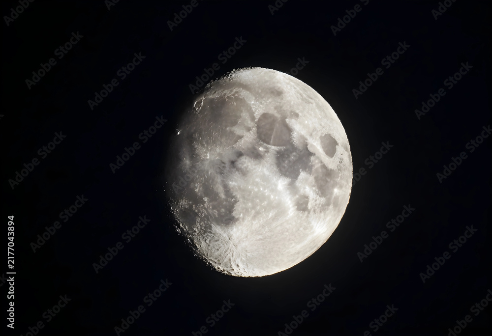 Fototapeta premium Astronomy and space exploration, full moon glowing in the dark night sky with detailed lunar craters and surface texture for science and nature themes