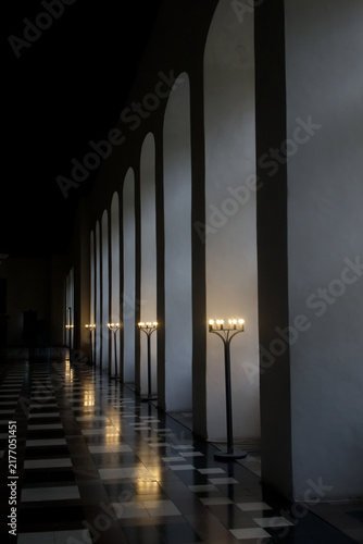 Modern Candelabras Row in Minimalist Hallway with Arches and Checkered Floor