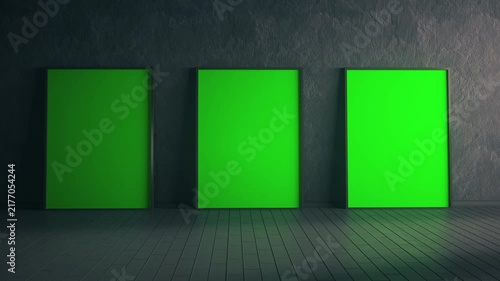 Three Glowing Green Screens Against Dark Textured Interior Wall