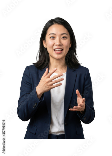 Asian business woman in navy blazer talks with expressive hand gestures for presentation