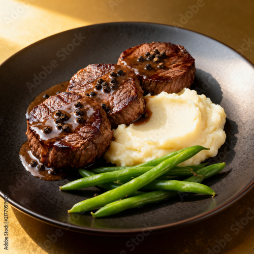 Grilled steak medallions with mashed potatoes and green beans