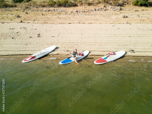 Woman relaxing on paddleboard enjoying summer vacation