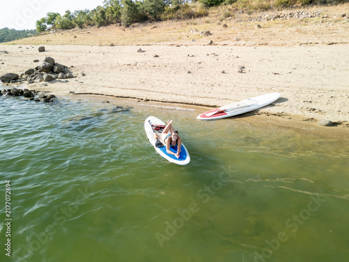 Woman relaxing on paddleboard enjoying summer vacation
