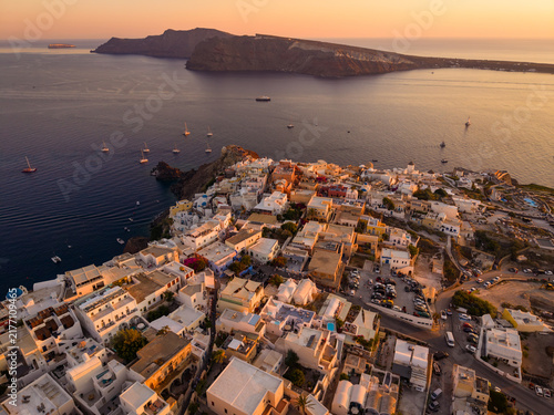 Fotografie Aerial drone view of white village rooftops and the volcano caldera in backgroun