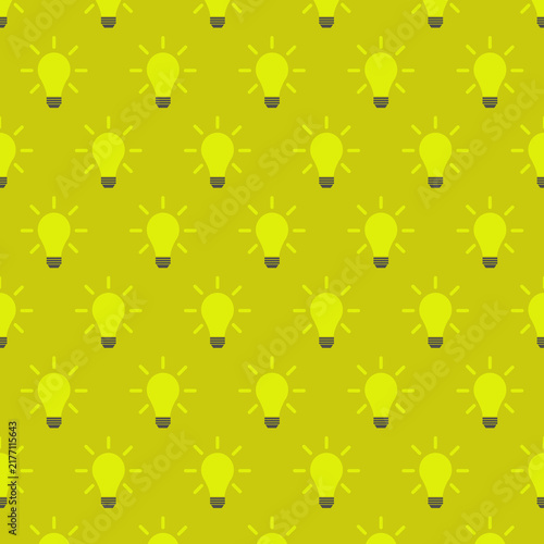 Seamless pattern of glowing yellow light bulbs with light rays repeating on a yellow background.