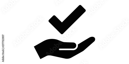 Fotografie Black silhouette icon of a checkmark held in an open hand representing task completion and approval