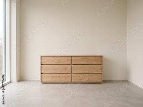 Minimalist light wooden sideboard against a neutral wall
