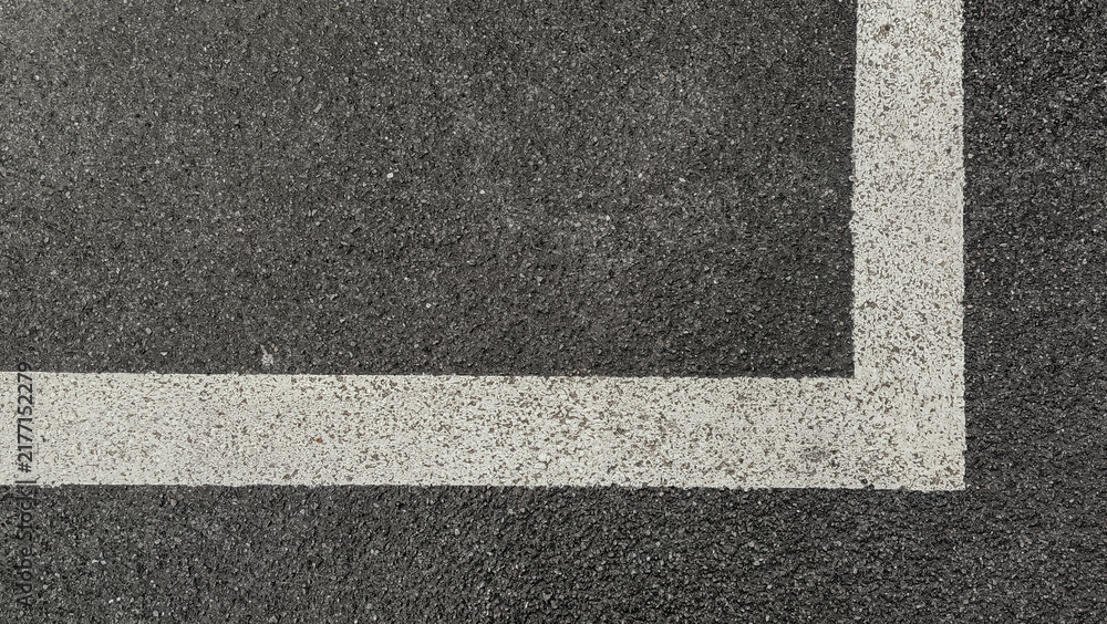 Fototapeta premium Dark asphalt road surface texture background with white painted line corner